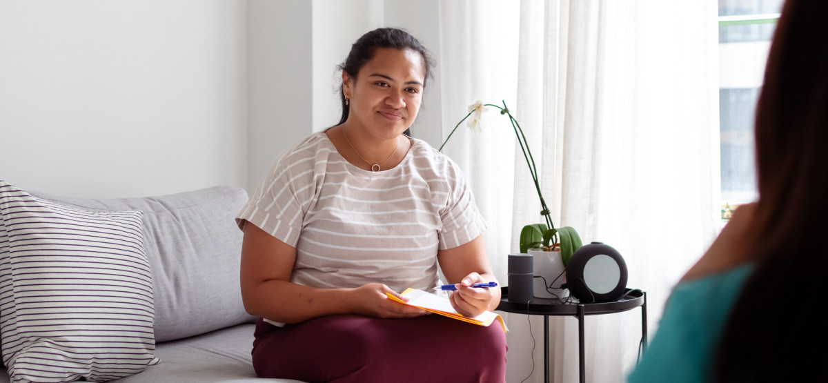 Social worker taking notes while providing support, representing the Service Finder for finding help services
